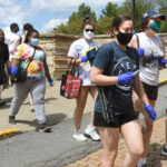 masked students cross North High Street